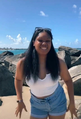 5. Sultry Asha Christine in White Crop Top at the Beach