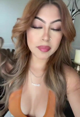 Desiree Montoya Shows Cleavage in Hot Orange Crop Top