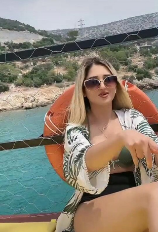 Sultry Eda Aslankoç Shows Cleavage in Olive Bikini on a Boat