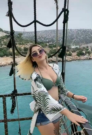 2. Luscious Eda Aslankoç Shows Cleavage in Olive Bikini Top on a Boat