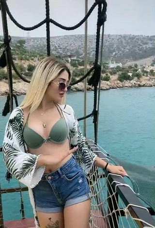 3. Luscious Eda Aslankoç Shows Cleavage in Olive Bikini Top on a Boat