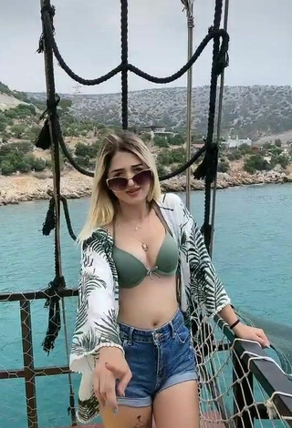 4. Luscious Eda Aslankoç Shows Cleavage in Olive Bikini Top on a Boat