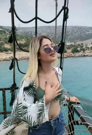 5. Luscious Eda Aslankoç Shows Cleavage in Olive Bikini Top on a Boat