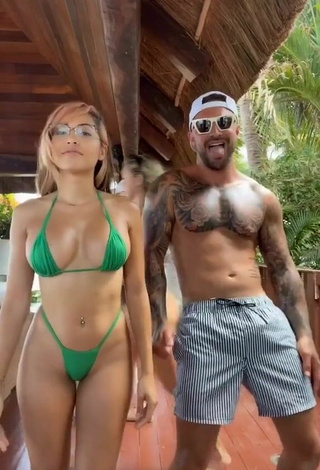 Sultry Maddy Belle Shows Cleavage in Green Mini Bikini