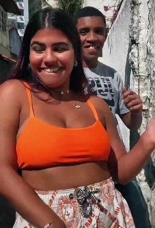 4. Seductive Julia Antunes Shows Cleavage in Orange Crop Top