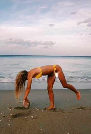 4. Wonderful Olivia Dunne in Yellow Bikini at the Beach while doing Fitness Exercises