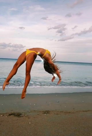 5. Wonderful Olivia Dunne in Yellow Bikini at the Beach while doing Fitness Exercises