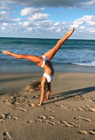 3. Really Cute Olivia Dunne in White Bikini at the Beach while doing Fitness Exercises