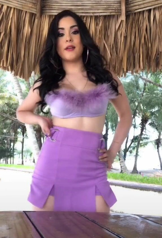 2. Sultry Ónice Flores Shows Cleavage in Purple Crop Top