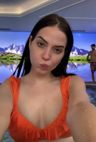 Sultry Sara Shows Cleavage in Orange Bikini Top at the Swimming Pool