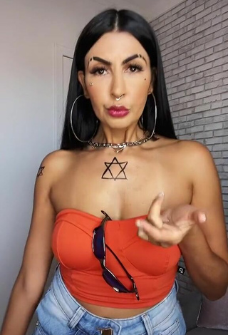 Sultry Sil Shows Cleavage in Electric Orange Tube Top