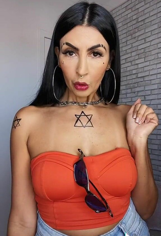 3. Sultry Sil Shows Cleavage in Electric Orange Tube Top