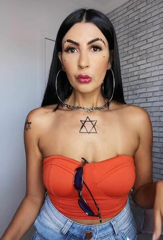 5. Sultry Sil Shows Cleavage in Electric Orange Tube Top