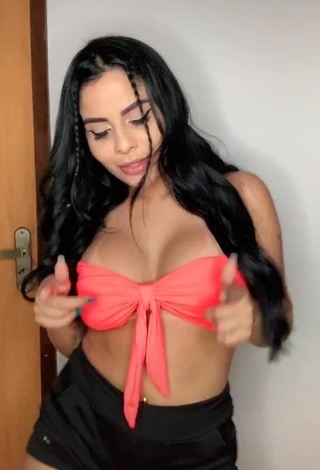 2. Luscious Tati Nunes Shows Cleavage in Orange Bikini Top