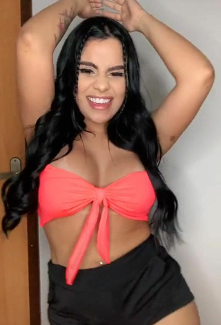 3. Luscious Tati Nunes Shows Cleavage in Orange Bikini Top