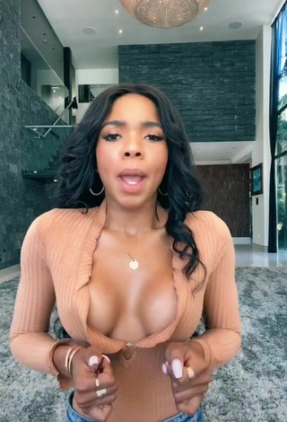 3. Sultry Teala Dunn Shows Cleavage in Peach Top