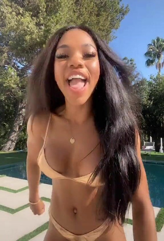 2. Hottest Teala Dunn Shows Cleavage in Golden Bikini at the Swimming Pool