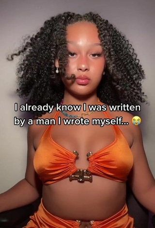 Titillating Veondre Mitchell Shows Cleavage in Orange Crop Top