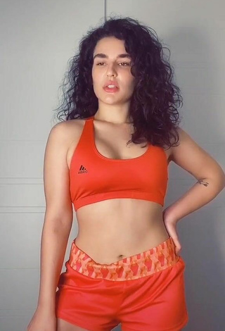 Luscious Kefera Buchmann Shows Cleavage in Orange Sport Bra