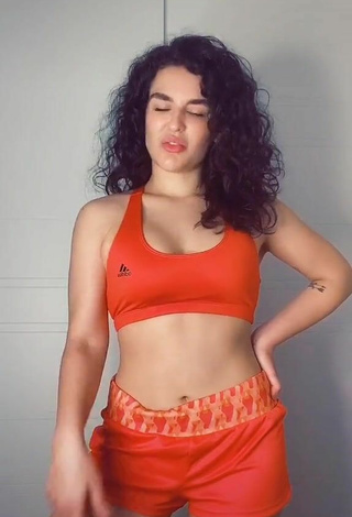 2. Luscious Kefera Buchmann Shows Cleavage in Orange Sport Bra