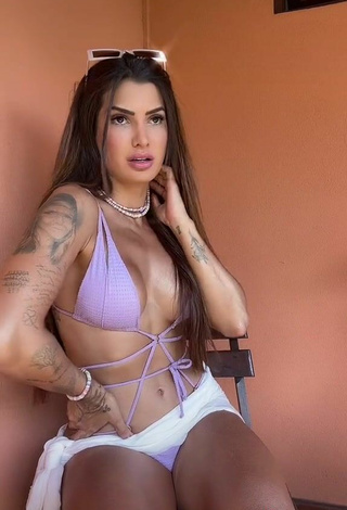 4. Seductive Marina Ferrari Shows Cleavage in Purple Bikini