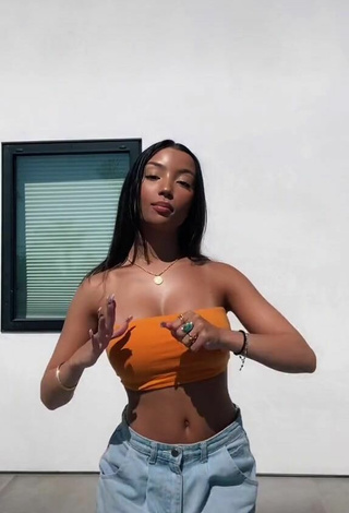 2. Sultry Alessya Farrugia Shows Cleavage in Orange Tube Top