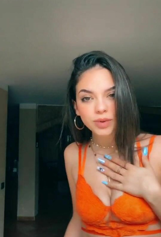 4. Sultry Giulia Paglianiti Shows Cleavage in Electric Orange Bra