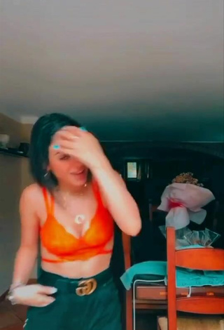 2. Luscious Giulia Paglianiti Shows Cleavage in Electric Orange Bra