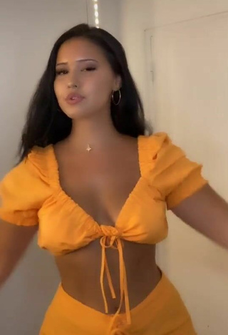 6. Hottest Anissa Shows Cleavage in Orange Crop Top