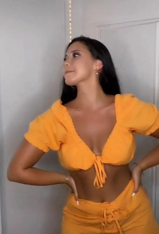 Titillating Anissa Shows Cleavage in Orange Crop Top