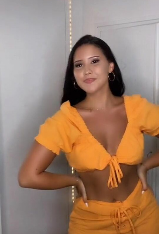 2. Titillating Anissa Shows Cleavage in Orange Crop Top