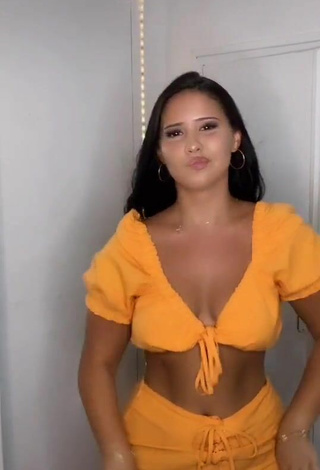 3. Titillating Anissa Shows Cleavage in Orange Crop Top