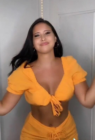 4. Titillating Anissa Shows Cleavage in Orange Crop Top