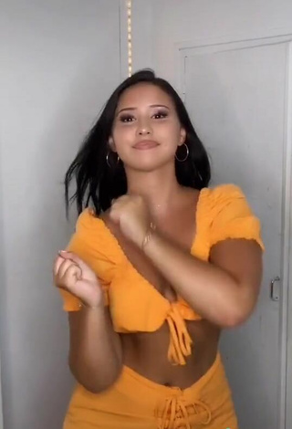 5. Titillating Anissa Shows Cleavage in Orange Crop Top