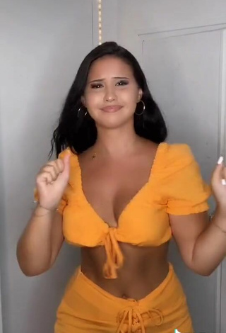 6. Titillating Anissa Shows Cleavage in Orange Crop Top