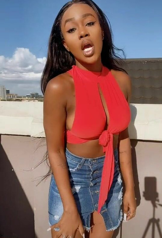 3. Titillating Azziad Nasenya Shows Cleavage in Orange Crop Top (Side Boob)