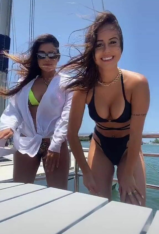 2. Cute Bianca Jesuino Shows Cleavage in Black Bikini on a Boat