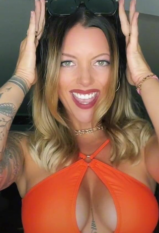 2. Sultry Aline Jost Shows Cleavage in Orange Crop Top (Side Boob)