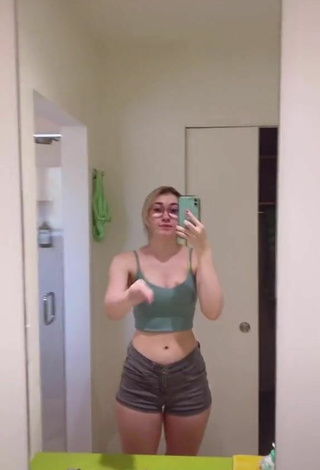 Titillating Sydney Shows Cleavage in Olive Crop Top