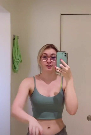 2. Titillating Sydney Shows Cleavage in Olive Crop Top