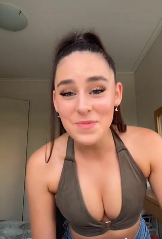 Titillating Caitlin Cummins Shows Cleavage in Olive Crop Top