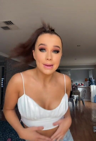 Sultry Caitlin Cummins Shows Cleavage in White Crop Top