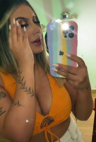 Sultry Laura Branquinho Shows Cleavage in Orange Crop Top