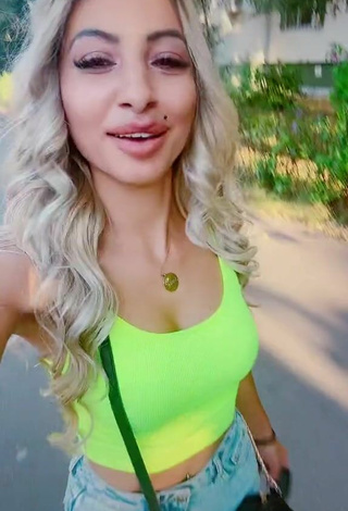 Titillating Adriana Ciriblan Shows Cleavage in Lime Green Crop Top in a Street