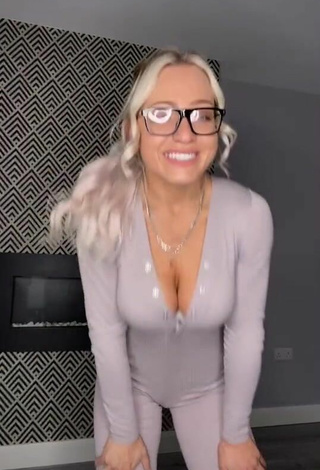 2. Luscious Maria Shows Cleavage in Grey Overall