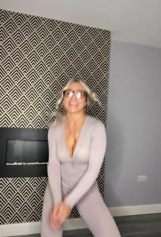 6. Luscious Maria Shows Cleavage in Grey Overall