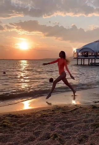 4. Sultry Diana Belitskay in Orange Bodysuit at the Beach