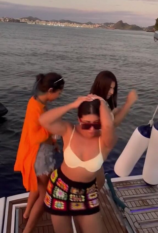 6. Sexy Ingrid Ohara Shows Cleavage in White Bikini Top on a Boat