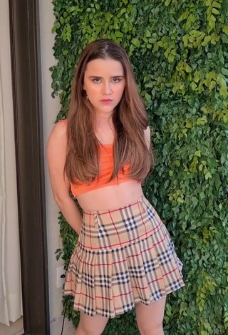 Titillating Letícia Pedro Shows Cleavage in Orange Crop Top