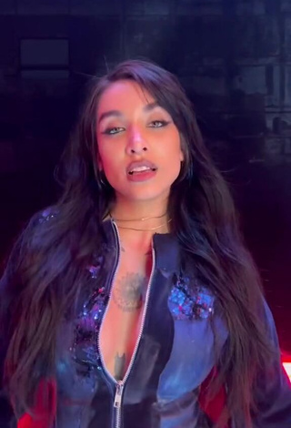 Luscious Maria Becerra Shows Cleavage in Black Overall (Side Boob)